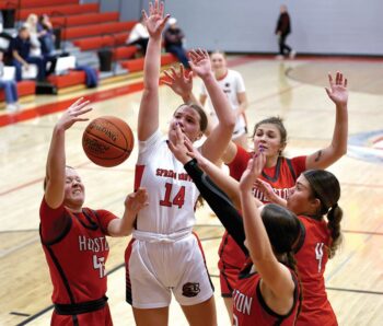 Spring Grove/Mabel-Canton’s Izabel Kaufmann is surrounded by Houston players including Rylee Boldt (left #43), Jorja Meyer (back right), and Bella Rodriguez (#4). In a key SEC girls basketball contest, SG/M-C notched a commanding 56-29 win. Photo by Craig Johnson