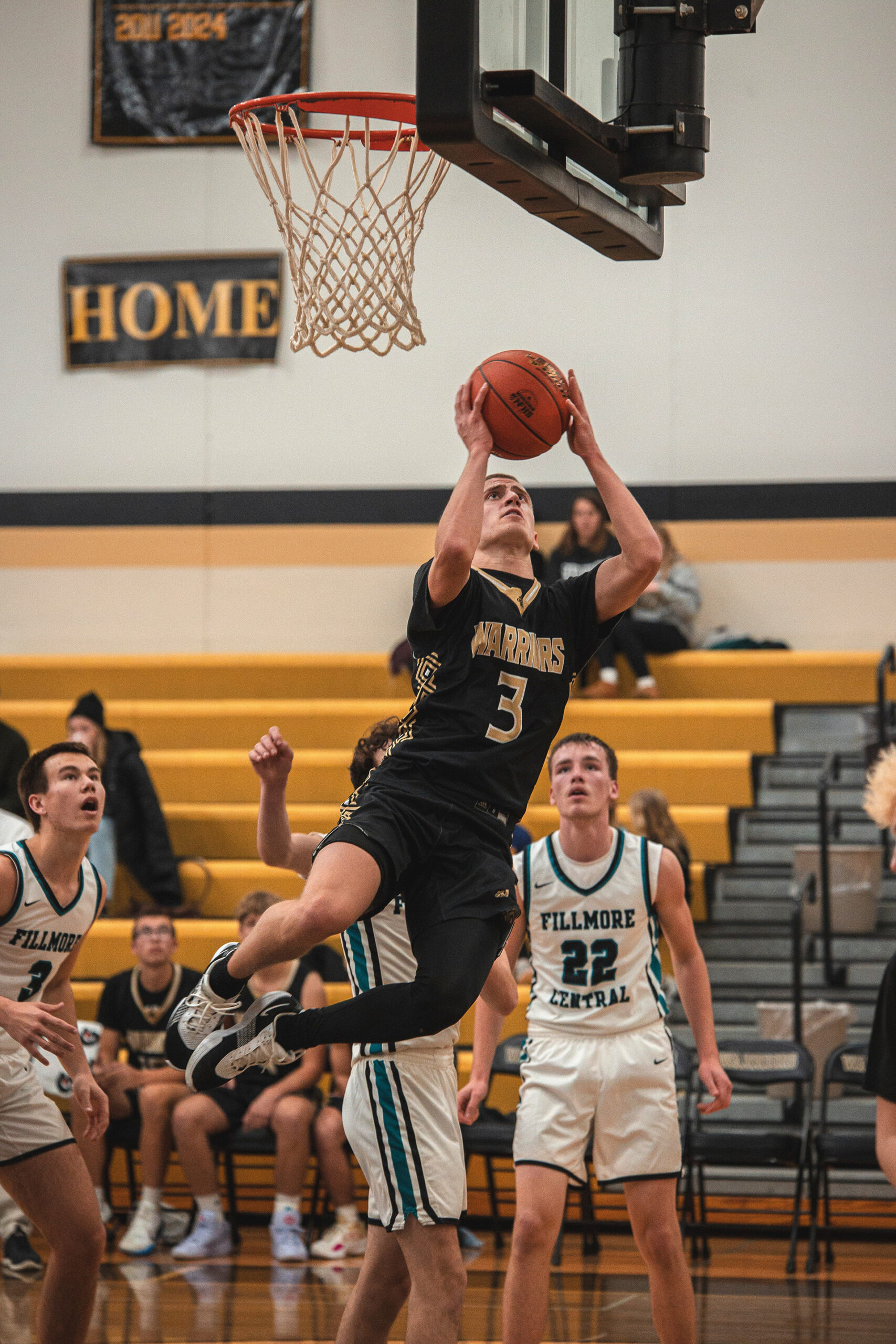 Caledonia’s Grant King contorts for a lay up in the Warriors 108-63 TRC win over Fillmore Central where the sophomore guard went for 26 (pts), 11 (asts), and 7 (stls). Photo by Isaac Blocker