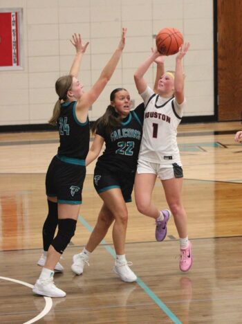 Houston’s Julia Swenson takes a lane shot against the defense of Fillmore Central’s Sophia Bronner (#24) and Maddie Topness (#22). FC ended each half on a run to post a 59-48 non-conference win. Photo by Paul Trende