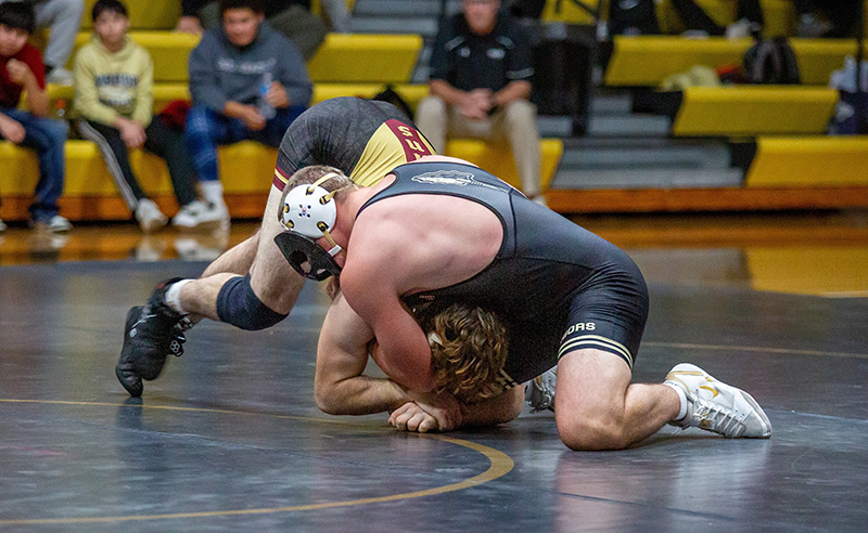 In maybe the dual’s most exciting match, Caledonia/Houston’s masked man Cooper Allen battles G-E-T/M-M’s #6 in D-II Aaron Dunigan. Allen fell by 15-13 decision, but he rebounded with a trio of wins at the Western Dubuque Duals. Photo by Emma Geiwitz