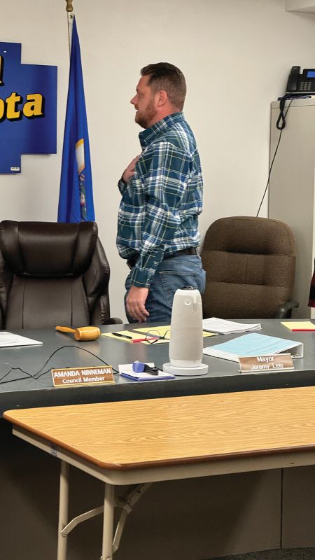 Caledonia Mayor Jeremy Leis leads his fellow council members and the audience in the Pledge of Allegiance at the November 24, 2025, council meeting. Photo by Charlene Corson Selbee