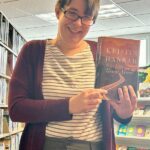 New Harmony Library Director Cara McCoy shares one of her favorite books to reccomend. Photo by Wanda Hanson