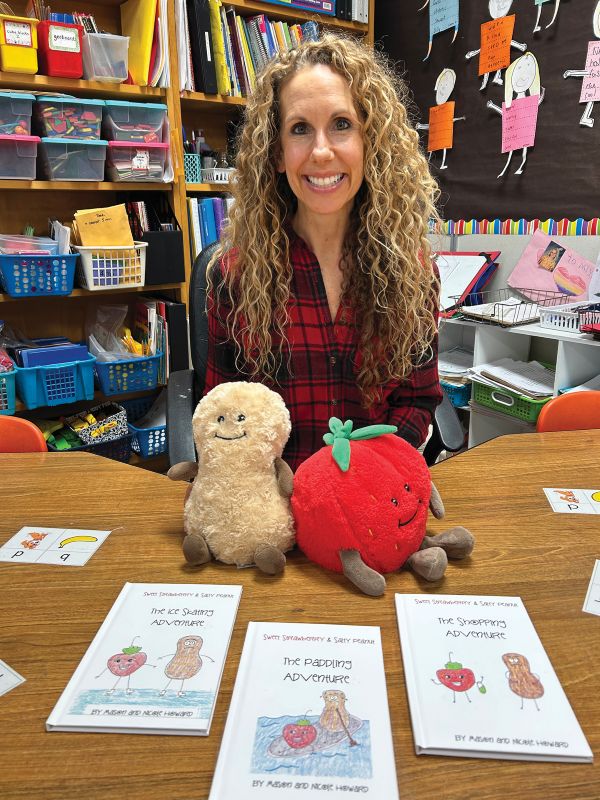 Nicole Howard with copies of the three books recently published and the Sweet Strawberry and Salty Peanut mascots in her second grade classroom at Lanesboro Schools. Photo by Wanda Hanson