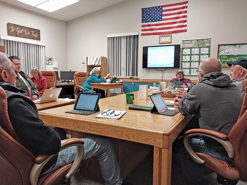 The Rushford Village Council deliberates on truck issues at the December 3 meeting. Pictured, clockwise from left: Councilor Bob Hart, City Attorney Joe O’Koren, City Treasurer Judy Graham, City Clerk Mary Miner, Zoning Administrator Jon Pettit, and Councilors Rick Ruberg and Mike Ebner. Photo by Kirsten Zoellner