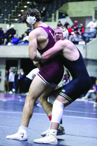 Caledonia/Houston’s Cooper Allen and Chatfield’s Will Boelter battle in a consolation match at the Bi-State wrestling tourney. Allen won the bout by 13-1 major decision and took sixth while Boelter took eighth (of 52 total wrestlers) at 215-pounds. Photo by Paul Trende