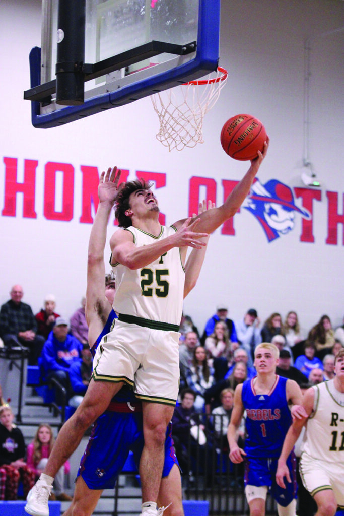Rushford-Peterson senior Landon Dahl goes baseline for a reverse layup versus #9 in Class A Southland in the Trojans’ 80-71 win. Dahl scored 9 of his 11 points in the second half to help R-P hand the Rebels (5-1) their first loss. Photo by Paul Trende