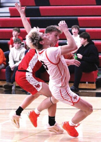 Lanesboro’s Quadyn Kettner takes the charge from LeRoy-Ostrander’s Reid Hungerholt in the Burros 83-33 SEC win. Team Burro, the SEC-East leader (4-1, 8-2), has won five in a row. Photo by Paul Trende
