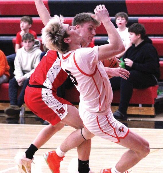 Lanesboro’s Quadyn Kettner takes the charge from LeRoy-Ostrander’s Reid Hungerholt in the Burros 83-33 SEC win. Team Burro, the SEC-East leader (4-1, 8-2), has won five in a row. Photo by Paul Trende