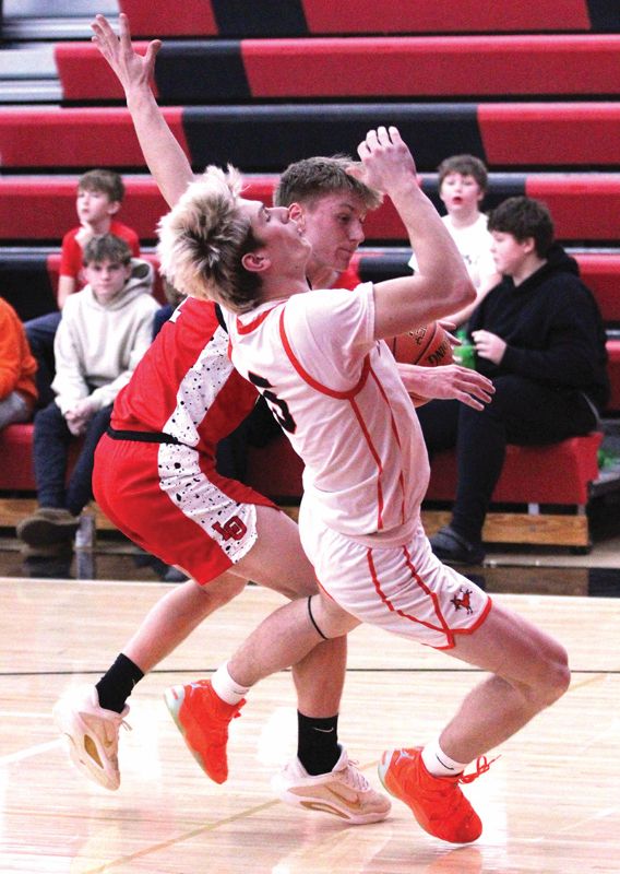 Lanesboro’s Quadyn Kettner takes the charge from LeRoy-Ostrander’s Reid Hungerholt in the Burros 83-33 SEC win. Team Burro, the SEC-East leader (4-1, 8-2), has won five in a row. Photo by Paul Trende