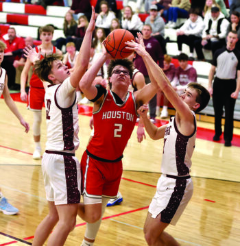 Houston’s Hector Steinfeldt tries to negotiate the defense of Chatfield’s Brooks Lea (left) and Ross Stoehr (right) in the Gophers’ non-conference 75-35 win. Photo by Craig Johnson