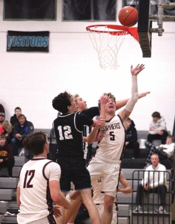 Chatfield’s Brandt McBroom gets by Fillmore Central defenders Clayton Schoepski (#13) and Bridon Bahl (behind) for a lay-up in the Gophers 85-51 win, one of three on the week as Chatfield improved to 4-2 in the TRC, 7-6 overall. Photo by Paul Trende