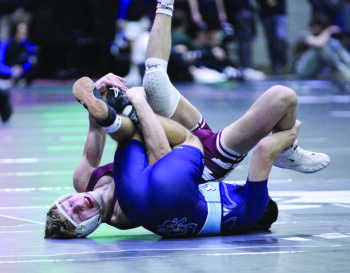 Chatfield’s Kaisen Johnson tangles the legs and has Alois Schlumpf on his back in a 132-pound semifinal at the Bi-State tourney. Johnson won the match by 7-1 decision and, going 4-1 for the tourney, took second of 55 wrestlers in his weight class. Photo by Paul Trende