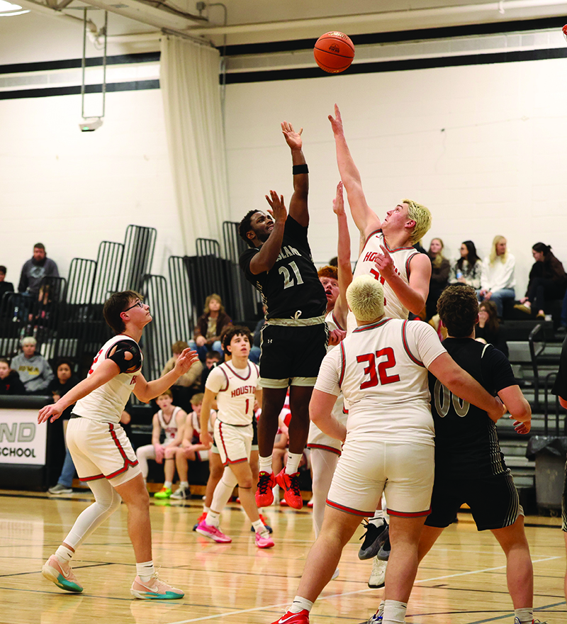 In a matchup of the number 21, Kingsland’s Kaaleem Reiland throws up a floater over Houston’s Atreyu Florin in the Hurricanes’ 64-59 SEC win.  It was their first victory and Florin had 22 points and 24 rebounds.Photo by Christine Vreeman