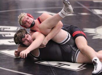 GMLOS’ Drake Payne cinches up a cradle on LARP’s Trygg Hegland at the Screamin’ Eagles’ quadrangular. Hegland fought off the pin, Payne won by major decision, but LARP beat the Bulldogs, D-E, and Century to sweep the quadrangular. Photo by Paul Trende