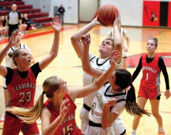 Caledonia’s Jessica Stendel battles inside against Lewiston-Altura’s Rinlee Bergan (#23) and Clara Kreidermacher (#15) in the Warriors 91-51 TRC win. The TRC-East leading Warriors (9-0, 12-3) have won five in a row. Photo by Craig Johnson