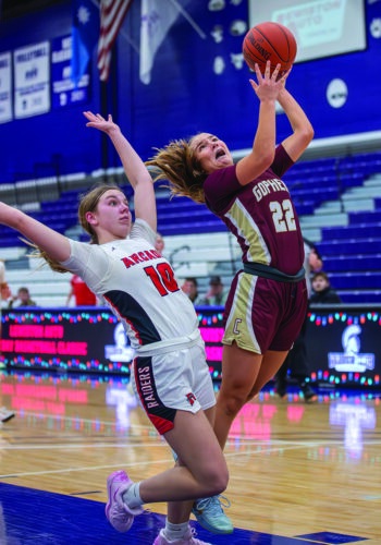 Chatfield’s Sedona Thompson and Arcadia’s Joselyn Lockington converge near the hoop in the Gophers’ narrow 59-57 win over the Raiders at the Lewiston Auto Holiday Tourney in Winona. Chatfield also beat Winona at the event, 65-39. Photo by Leif Erickson