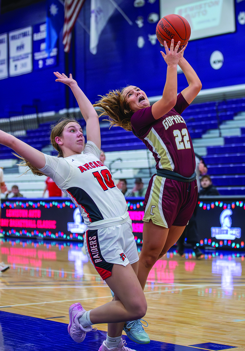 Chatfield’s Sedona Thompson and Arcadia’s Joselyn Lockington converge near the hoop in the Gophers’ narrow 59-57 win over the Raiders at the Lewiston Auto Holiday Tourney in Winona. Chatfield also beat Winona at the event, 65-39. Photo by Leif Erickson