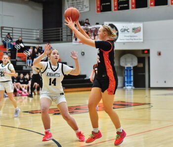 Lanesboro’s Emma Root makes the pass past Kingland’s Chloe Drury-DeBoer in the Burros’ 44-31 SEC win. Photo by Ron Mayer