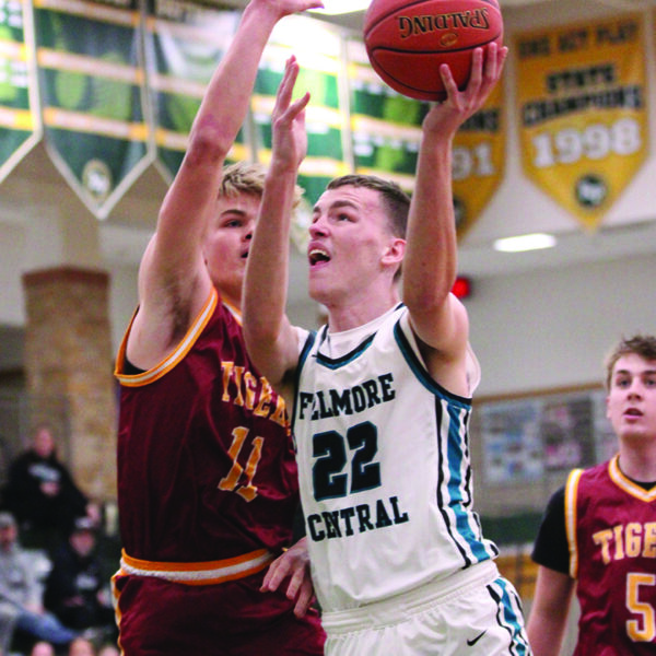 Fillmore Central’s Logan Illg takes the ball to the hoop defended by Rushford-Peterson’s Carson Johnson. The latter went for 17 (pts), 11 (rebs), and 8 (asts) in the Trojans’ 93-35 win, part of a 3-0 R-P week. Photo by Paul Trende