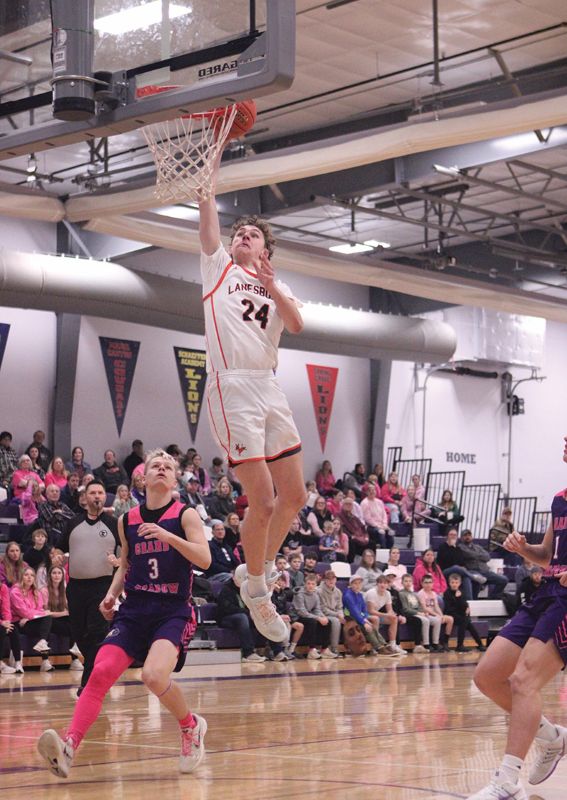 Lanesboro’s Nick Taylor soars in for the dunk as Grand Meadow’s Blake Hubbard can only watch. The Burros downed GM in a key cross-division SEC game by 57-47 final. Lanesboro (7-2, 11-3) leads the East over nearest foe Mabel-Canton (5-3, 8-5). Photo by Paul Trende