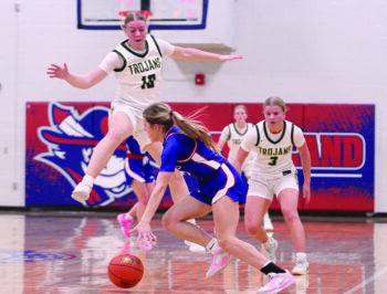 Rushford-Peterson sisters Ava Helgemoe (airborne) and Emily Helgemoe (right) apply defensive pressure to Southland’s Brynlee Koenigs in the teams’ notable non-conference matchup, a 64-57 Rebel win. Photo by Paul Trende