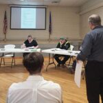 A representative of WHKS Engineering describes the plan for the city’s well and well-house project. Photo by Ben Bisbach