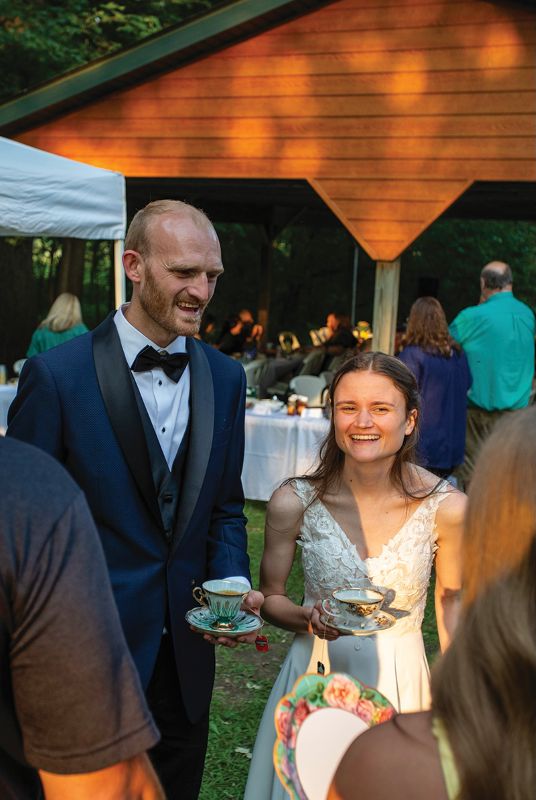 Kaylee and Michael talking with guests at the tea-party themed wedding reception held at Niagara Cave, Harmony, Minn. Photo by Daryll Anderson
