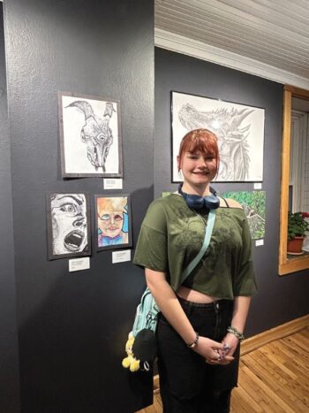 Caitlyn Heuser, from Rushford-Peterson, poses with her artwork (top left). Caitlyn downloaded a model picture from the internet and worked on the piece for about six hours. Photo by Wanda Hanson