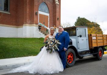 Jacklyn and Ryan at the church in front of their getaway vehicle, the 1926 REO Speedwagon. Photo submitted