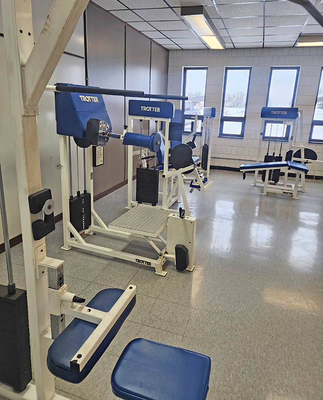 Selectorized weight machines line part of the fitness center at Wykoff Commons, providing guided strength-training options in an open, low-traffic layout. Photo by Zech Sindt