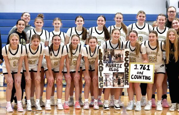 Caledonia girls basketball had a big week, beating Cotter/Hope Lutheran 77-55 to clinch a share of the TRC-East title and senior Aubrie Klug (holding sign) became the Warriors girls all-time leading scorer with over 1,761 career points and counting. The #10 in AA Warriors (15-3) have won eight in a row. Photo by Craig Johnson