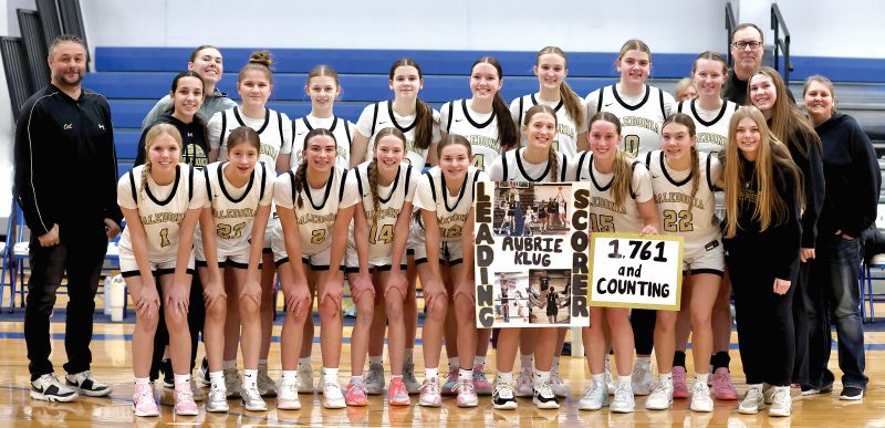 Caledonia girls basketball had a big week, beating Cotter/Hope Lutheran 77-55 to clinch a share of the TRC-East title and senior Aubrie Klug (holding sign) became the Warriors girls all-time leading scorer with over 1,761 career points and counting. The #10 in AA Warriors (15-3) have won eight in a row. Photo by Craig Johnson
