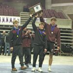 Chatfield’s Layne Root, Kaisen Johnson and Will Boelter grab the Section 1A wrestling title trophy after taking down Goodhue 33-31 in the finals. The Gophers three-peated as section champs and head back to state for a double encore. Photo by Paul Trende
