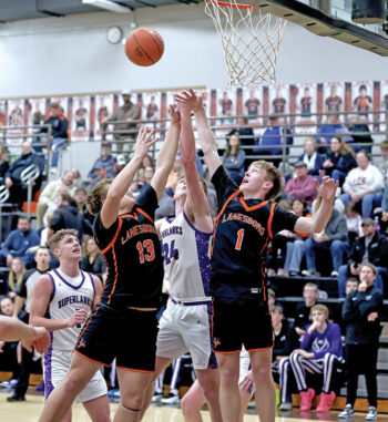 Lanesboro’s Preston Clarke (left) and Conor Danielson (right) vie with Grand Meadow’s Logan Grafe for a rebound in the Burros’ 69-47 SEC win. SEC-East leading Lanesboro has won seven in a row and 14 of their last 15. Photo by Craig Johnson