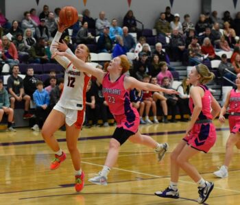 Grand Meadow’s Gracie Foster tries to get back on defense to defend the shot of Lanesboro’s Emma Root in the Burros’ 57-54 SEC win, the fourth in a row for team orange and black. Photo by Ron Mayer