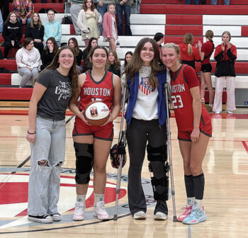 On January 26, Houston senior guard Avery Kingsley (second from left) scored her 1,000th career point in a loss to Lewiston-Altura. Above, she is honored at a February 9 home game versus Lanesboro. She is pictured (left to right) with her sister Priya, Houston girls all-time leading scorer Sydney Torgerson, and classmate (fellow 1,000-point scorer) Aubry Boldt. Photo by Emma Geiwitz