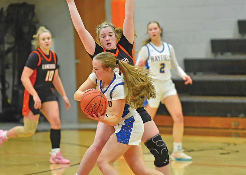 Lanesboro’s Cora Mayer defensively pressures a Hayfield/Schaeffer Academy player in the teams’ non-conference game. After five straight losses to teams with a 73-30 record, the Burros took down the Class A #8-ranked Vikings by 74-65 final. Photo by Ron Mayer