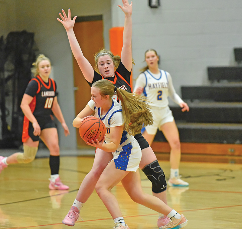 Lanesboro’s Cora Mayer defensively pressures a Hayfield/Schaeffer Academy player in the teams’ non-conference game. After five straight losses to teams with a 73-30 record, the Burros took down the Class A #8-ranked Vikings by 74-65 final. Photo by Ron Mayer