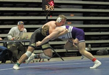 Goodhue’s #3-ranked Jack Carlson pressures Caledonia/Houston’s #4-ranked Cooper Allen, warranting a match-deciding stalling call. Carlson thus won the match 2-1 in overtime and the Wildcats won the Section 1A semifinal over the Warriors 42-20. Photo by Paul Trende