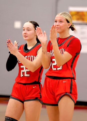Houston players Olivia Yohe and Aubry Boldt applaud amidst the Hurricanes’ Section 1A Round of 16 win over Faribault B.A., 61-56. The ‘Canes move on to face top-seed NRHEG. Photo by Craig Johnson