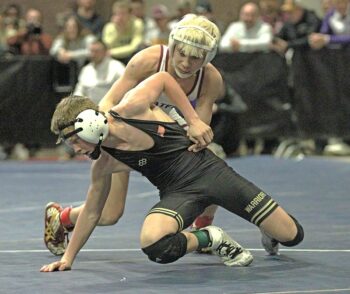 Chatfield’s Joey Cady allows Caledonia/Houston’s Kiptyn Meiners to escape in a 107-pound section finals match. Cady, ranked #3, notched a 21-6 tech fall win but both qualified for state. Photo by Paul Trende