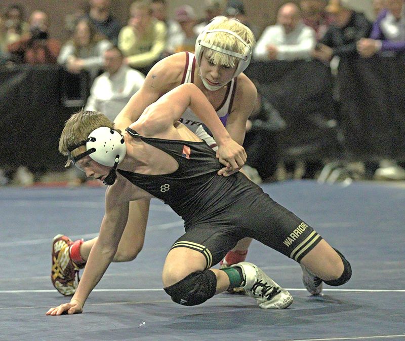 Chatfield’s Joey Cady allows Caledonia/Houston’s Kiptyn Meiners to escape in a 107-pound section finals match. Cady, ranked #3, notched a 21-6 tech fall win but both qualified for state. Photo by Paul Trende
