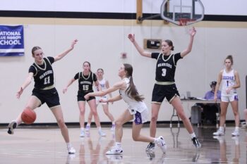 Caledonia’s Kensey King and Aubrie Klug try to hem in Goodhue’s Lola Christianson in the teams’ Section 1AA clash. The Wildcats hit 30 free throws to post a 91-82 comeback win. Photo by Paul Trende