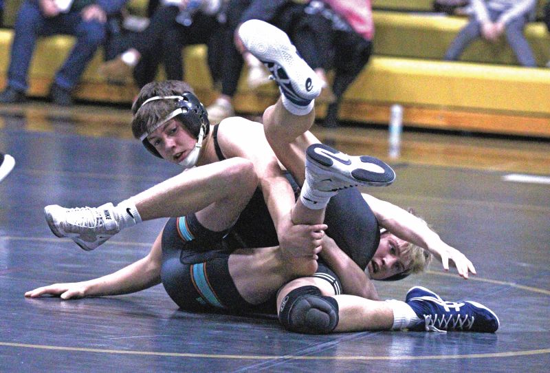 Caledonia/Houston’s Nolan Conway (left) and FCLMC’s Ben Norby (right) tangle at Caledonia’s triangular with the Wolves and Dover-Eyota. Conway won by third period fall while trailing in the match and Cal/Hou beat D-E 36-25 and the Wolves 47-22 to sweep the triangular. Photo by Paul Trende
