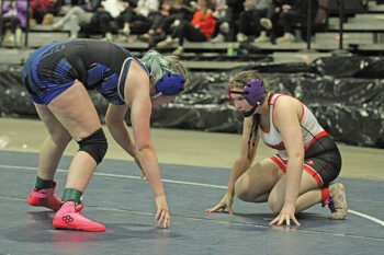 GMLOS’ Brandy Christenson locks in on her opponent Zoey Bailey of Eastview in a Section 2 155-pound true second match. Christenson went 5-1 for the tourney including winning the above bout by 14-3 major to earn her second state qualification (2024). Photo by Paul Trende