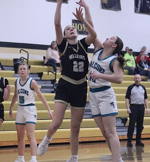 Fillmore Central’s Kyla Hellickson looks to get a piece of the shot of Caledonia’s Peyten Felten in the teams’ TRC finale. The Warriors topped the Falcons 64-22 to rip through league play undefeated (14-0) and they also improved to 20-8 on the year. Photo by Paul Trende