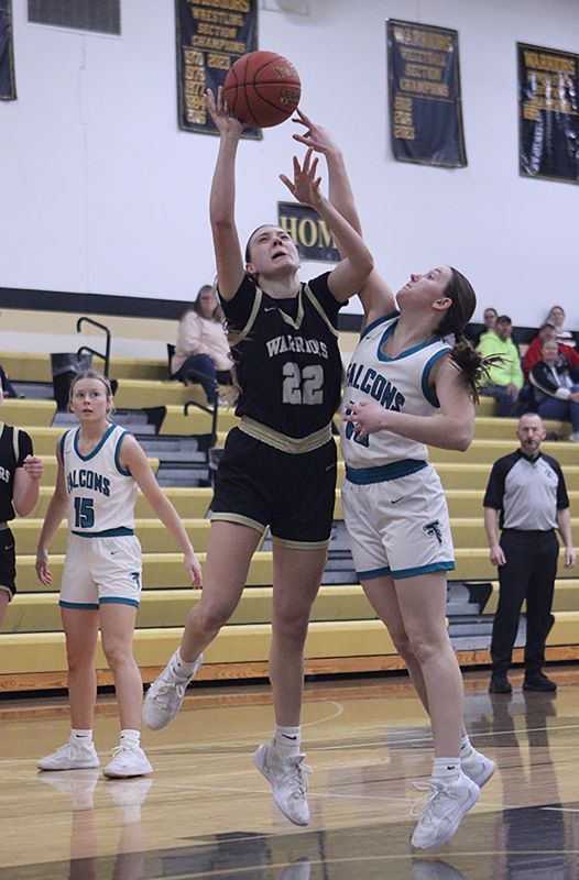 Fillmore Central’s Kyla Hellickson looks to get a piece of the shot of Caledonia’s Peyten Felten in the teams’ TRC finale. The Warriors topped the Falcons 64-22 to rip through league play undefeated (14-0) and they also improved to 20-8 on the year. Photo by Paul Trende