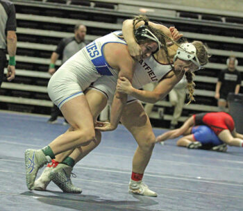 Chatfield senior Eve Goetzinger tries for the throw of Owatonna’s Aliah Fischer in a 148-pound final match at the Section 1 girls individual wrestling tourney. Fischer won the match, but Goetzinger earned a trip to state nonetheless as runner-up. Photo by Paul Trende