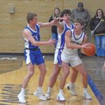 Grand Meadow’s Carter Glynn is hemmed in by Mabel-Canton defenders Nolan Garness and Cael Wangsness in the Cougars notable 79-47 SEC win. M-C improved to 10-5. Photo by Heather Kleiboer