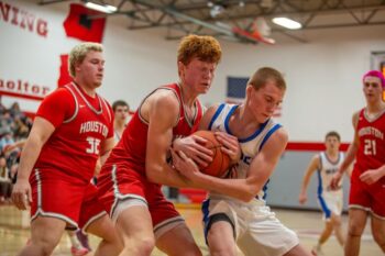 Mabel-Canton’s Nolan Garness battles Houston’s Tilden Witt for a loose ball in the Cougars’ 70-49 win. M-C wrapped up the season with a pair of wins (the other over SEC-East champ Lanesboro). Russ Larson’s group is 18-8 and the win total is the most in Mabel since 1976-1977! Photo by Emma Geiwitz